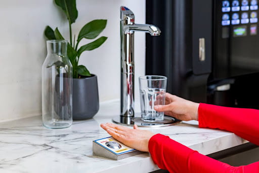 A woman using the accessible HydroTap