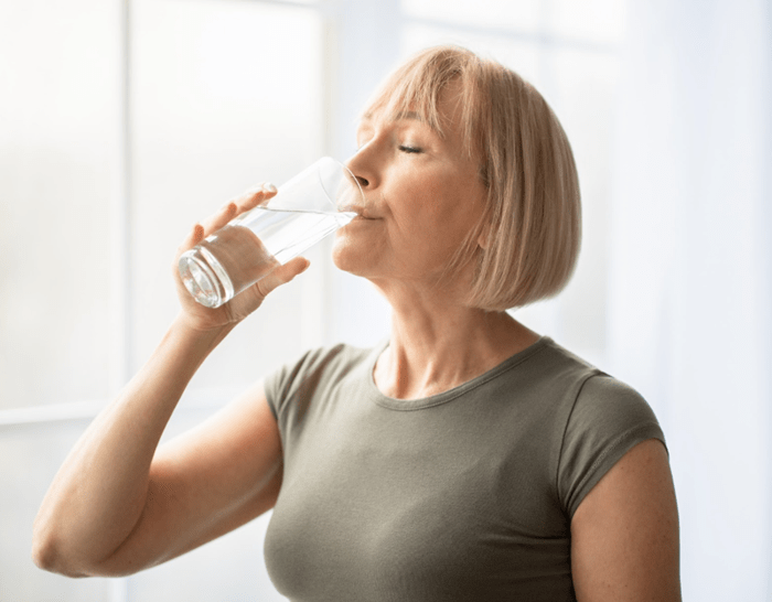 Woman drinking a glass of water.