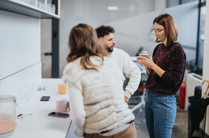 Group of professionals talking at work