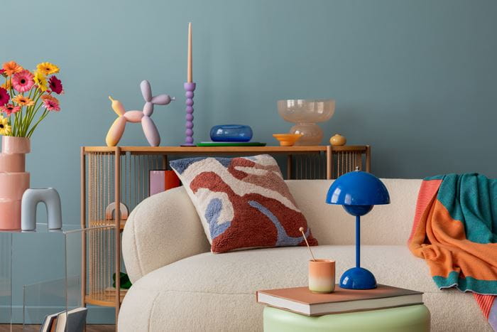 A living room with antique furniture and leafy plants